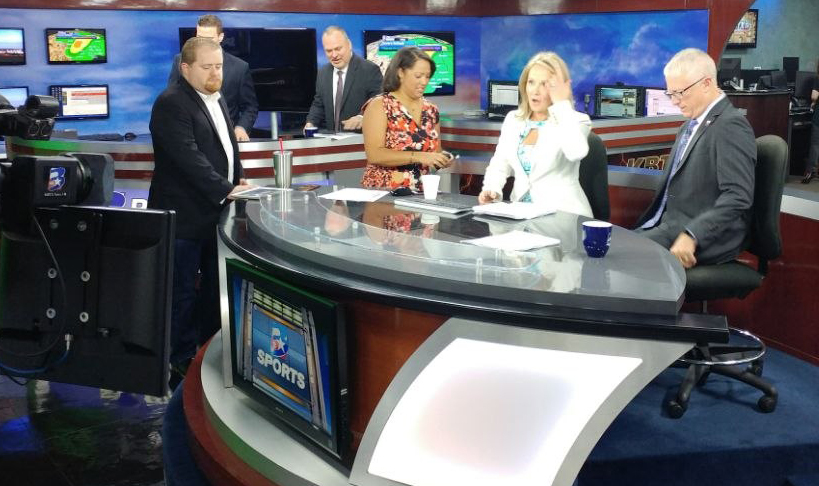 Anchors and producers at the news desk