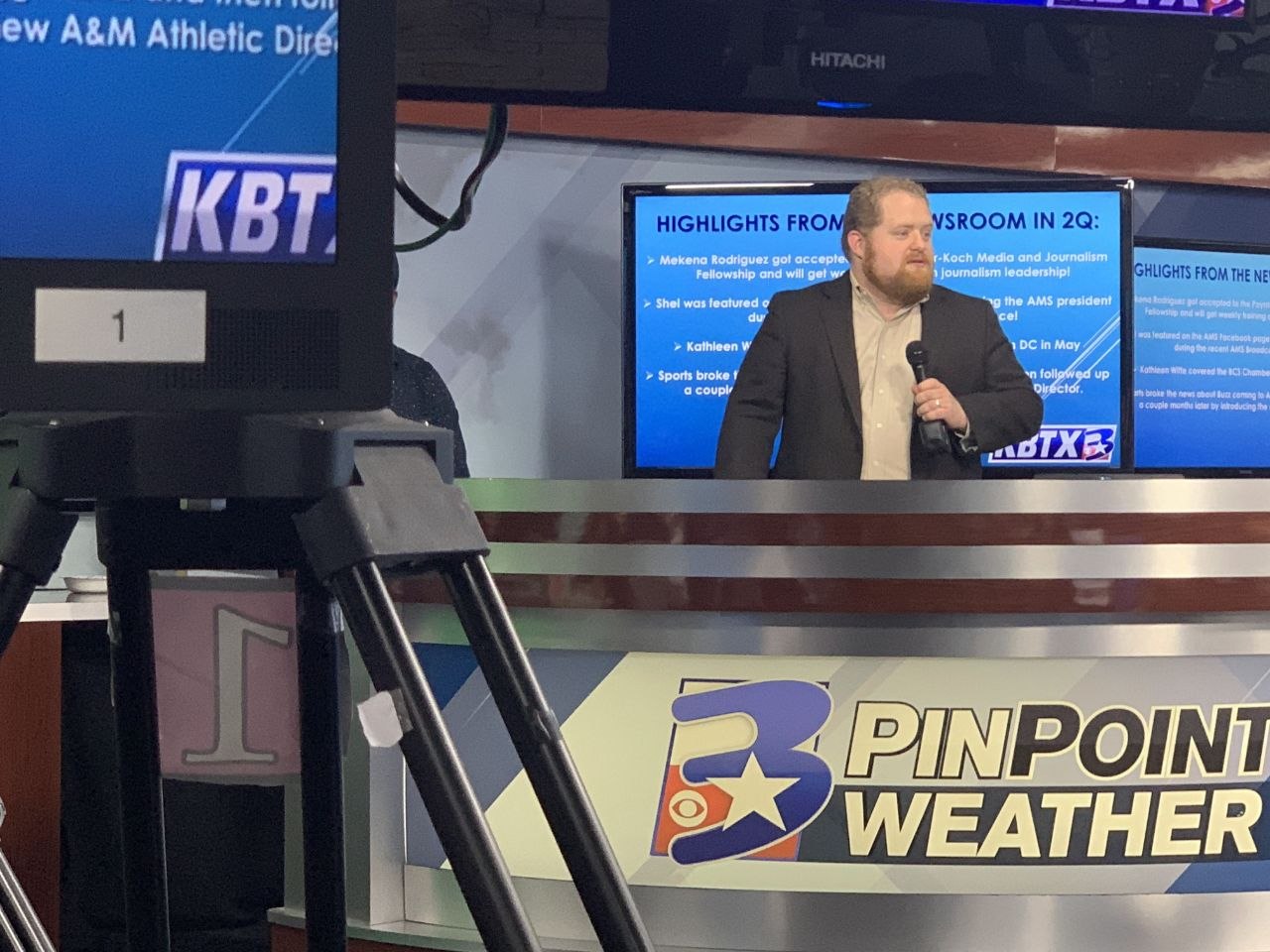 Josh Gorbutt presenting newsroom quarterly highlights on the KBTX studio floor